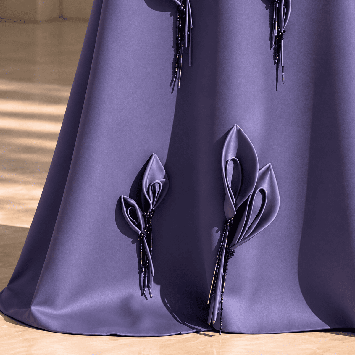 Detail of the asymmetric fold-over off-shoulder neckline on the dusty purple Vibia gown