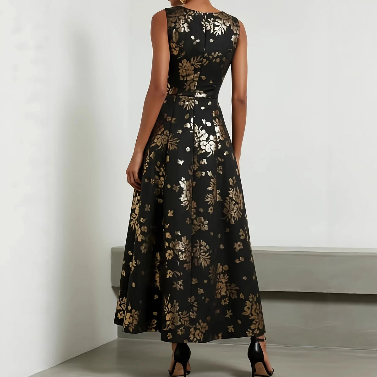 Back view of Amunet black and gold floral dress showing back zip and flared ankle-length skirt