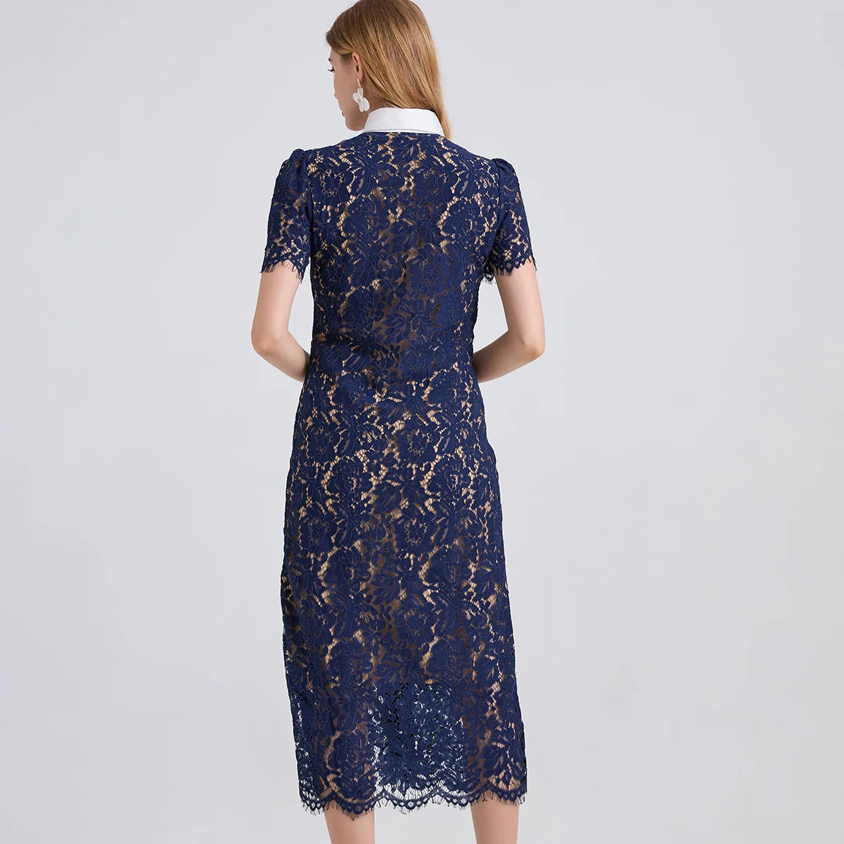 Back view of Taweret navy blue fitted lace midi dress with short sleeves and scalloped lace hem