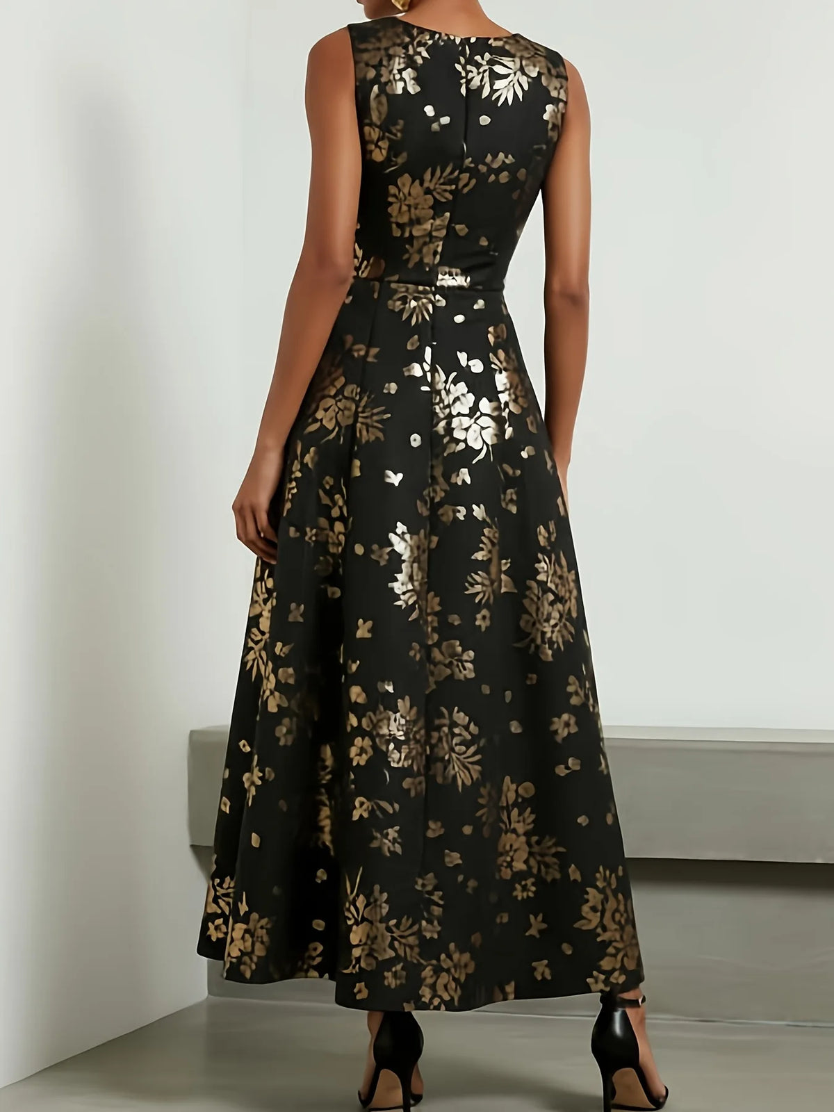 Amunet black and gold floral A-line dress, back view with zip and pleated skirt