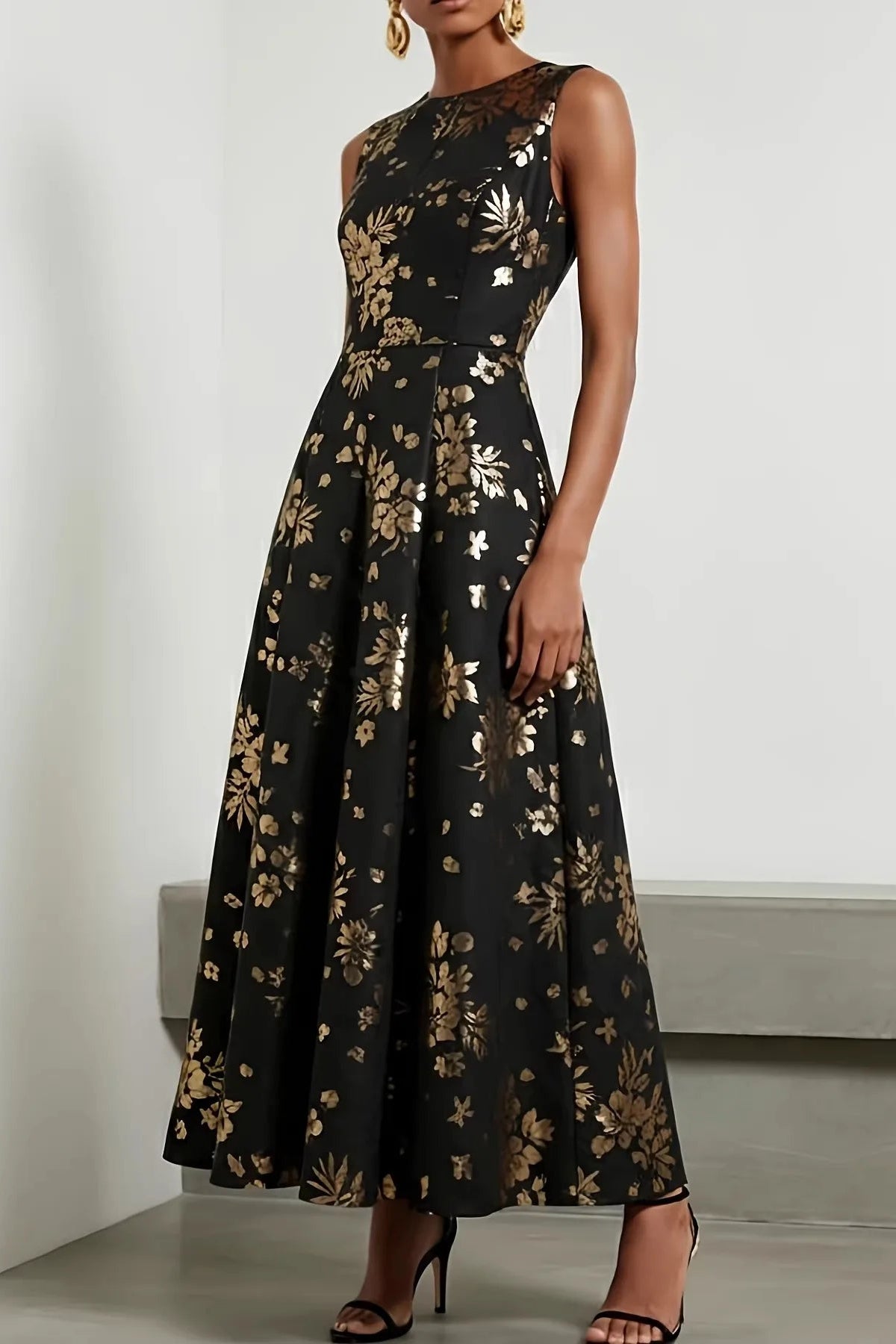 Amunet sleeveless A-line dress in black with metallic gold floral print, ankle length